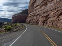 the winding road runs through a mountainous area in utah usa, along with many rocky cliffs, mountains and river