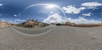 the 360 camera view shows an empty mountain road near rocks and a small truck at the right side