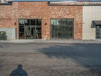 the empty street outside of the business district is empty and deserted with vehicles parked in it