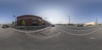 a picture of the intersection in a parking lot with lots of cars on the side walk