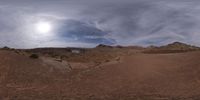 a 360 - roll shot of some rocks and dirt by a body of water in the desert