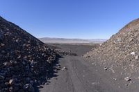 the gravel road is lined by rocks, dirt and boulders in this view from above