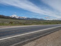 USA's Rural Landscape: Cloudy Mountains and a Serene Road