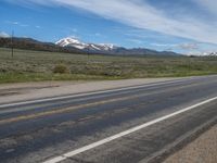 USA's Rural Landscape: Cloudy Mountains and a Serene Road