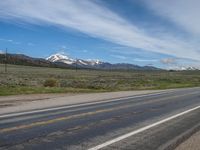 USA's Rural Landscape: Cloudy Mountains and a Serene Road