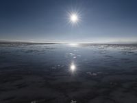 the sun is shining brightly over the horizon of the water's surface as it reflects the sky