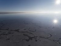 the sun is shining brightly over the horizon of the water's surface as it reflects the sky