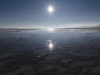 the sun is shining brightly over the horizon of the water's surface as it reflects the sky