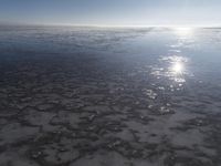 the sun is shining brightly over the horizon of the water's surface as it reflects the sky