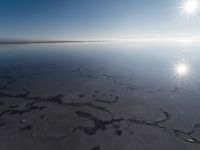 the sun is shining brightly over the horizon of the water's surface as it reflects the sky