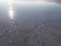 the sun is shining brightly over the horizon of the water's surface as it reflects the sky