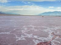 the large salt panami and clouds have melted over it to create the pink hues