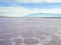 the large salt panami and clouds have melted over it to create the pink hues