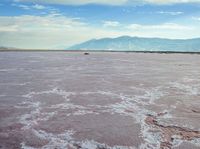 the large salt panami and clouds have melted over it to create the pink hues