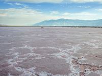 the large salt panami and clouds have melted over it to create the pink hues