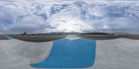 an image of the underside of a half pipe ramp at a skate park taken in a fish eye lens