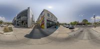 a 360 - view of a parking lot showing cars parked on the side of a street