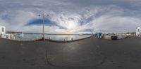 a fish eye view shows the dock at a marina and a small boat is docked nearby