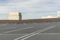 a rooftop parking lot in a city with buildings and a sign that reads'i have no place for people to move here