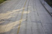 an overhead view looking down at a yellow line on a street in an empty city