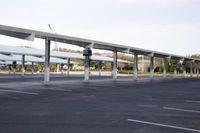 a row of cars parked in a parking lot outside of a building under construction space