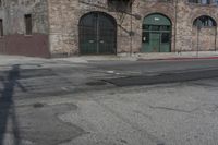 a car is parked on the side of a street by an old building in downtown