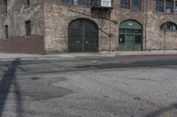 a car is parked on the side of a street by an old building in downtown