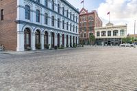 the cobblestone streets are empty and cobbled in, but many buildings are seen