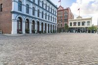 the cobblestone streets are empty and cobbled in, but many buildings are seen