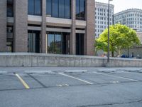 a street with a building near the building in the middle and on the left of which is a parking lot, as shown in this photo