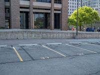 a street with a building near the building in the middle and on the left of which is a parking lot, as shown in this photo