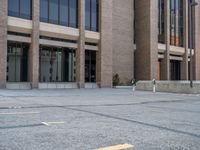 a street with a building near the building in the middle and on the left of which is a parking lot, as shown in this photo