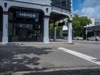 a small business in a city on the street corner with signs on it that read,'heritage henge '