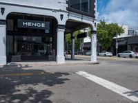 a small business in a city on the street corner with signs on it that read,'heritage henge '