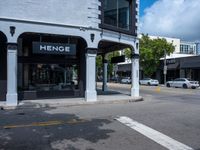 a small business in a city on the street corner with signs on it that read,'heritage henge '