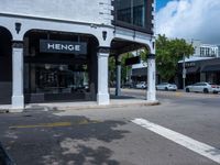 a small business in a city on the street corner with signs on it that read,'heritage henge '