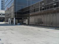 large building with many windows near a parking lot with a fire hydrant on the side