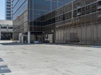 large building with many windows near a parking lot with a fire hydrant on the side