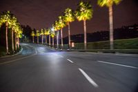 an empty road with trees and a bright light near it at night time during the day