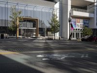 view from across the road at a building with a bicycle lane in front of it