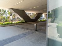 an image of the outside area of a modern structure with metal pillars and concrete pillars