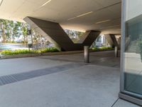 an image of the outside area of a modern structure with metal pillars and concrete pillars