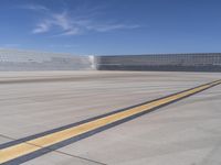 an airport has a large field and lots of buildings in the background it has yellow lines that mean,