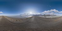 multiple street lines and mountains on the horizon in the desert area in an image from fisheye view