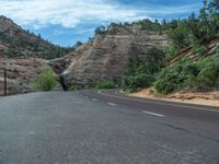 USA's Utah: A Road amidst Mountains and Clouds