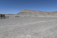 a red truck is driving through the rocky landscape of the desert of an arid area