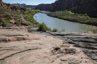 there is a view down a canyon with rocks on the bottom and a river below