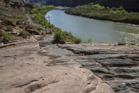 there is a view down a canyon with rocks on the bottom and a river below