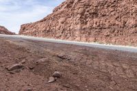 the road on the side is marked with rocks as if from a passing car driving through