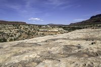 a vast expanse in the desert with the sky above and trees on the ground below